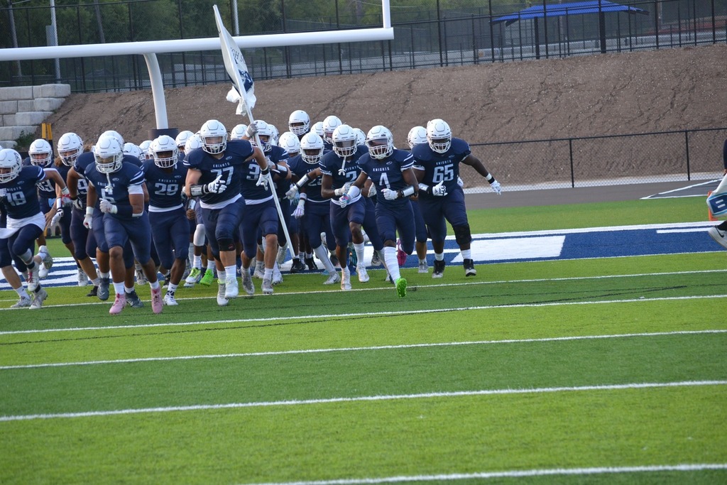 nicolet football players running onto the field